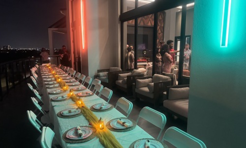 a large table with chairs and plates